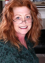Older Redhead Veronica Smith Strips Naked On The Desk.