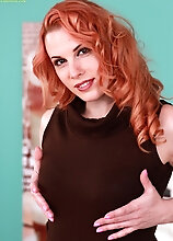 Older Redhead Genny Red Spreads Her Trimmed Pussy.